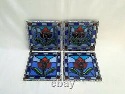 A vintage signed set of four stained glass panels, 1 pair are three dimensional