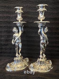 Buccellati style pair of silver candlesticks of putti holding cornucopia signed